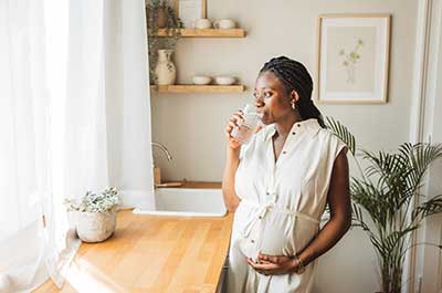 pregnant woman drinking water