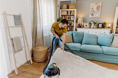man vaccuming