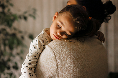 child sleeping on parent