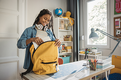 Student packing backpack
