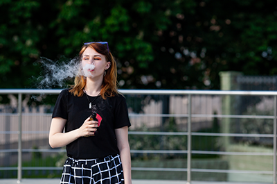 teen vaping outside