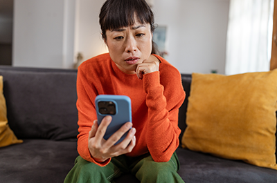 worried woman looking at phone