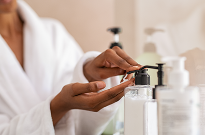 woman applying hand lotion