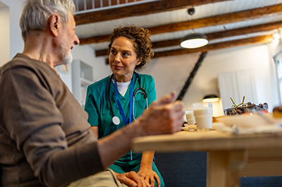 older man talking to medical professional