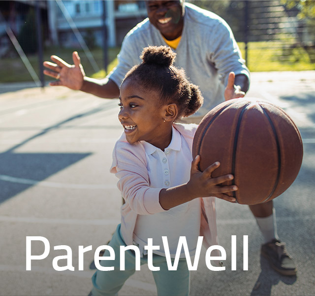 dad holding tolder son