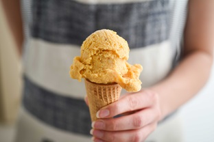 banana ice cream hand holding cone