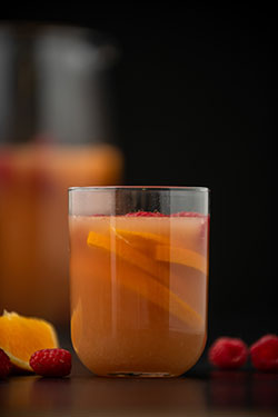 A glass with ice featuring raspberry tea