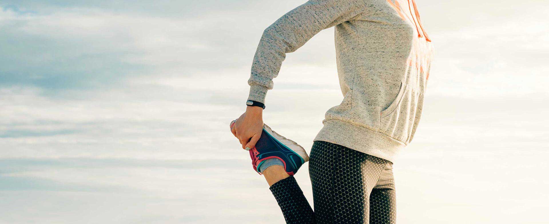 woman stretching before running