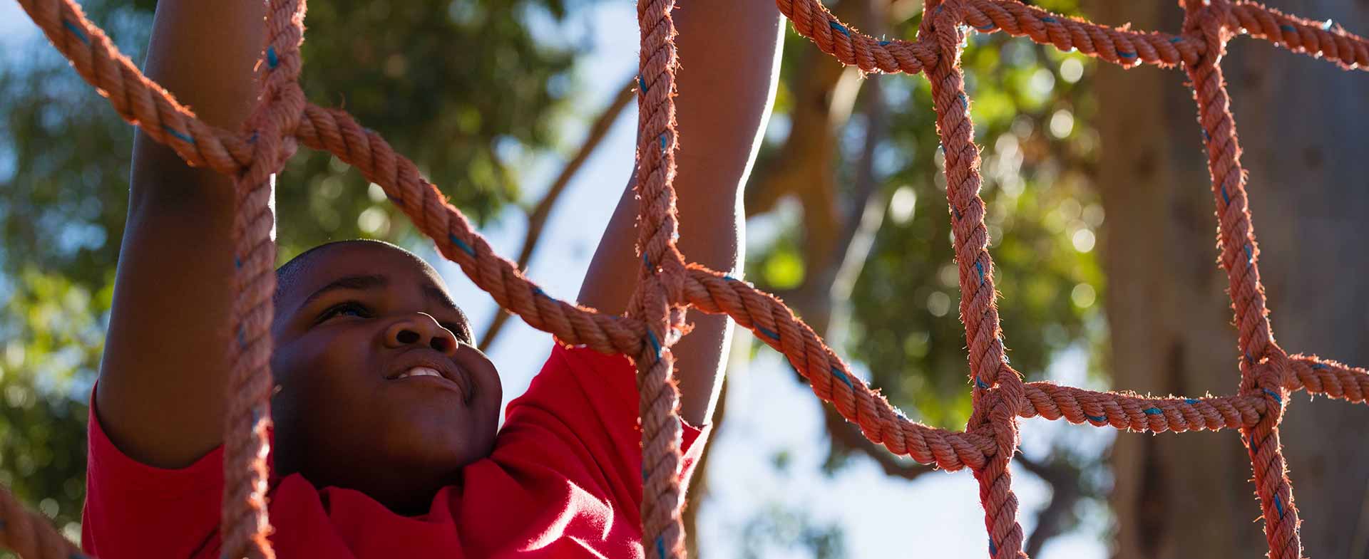 boy climbing rope