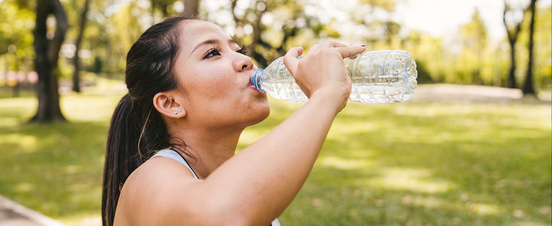 Athletic woman drinking too much water