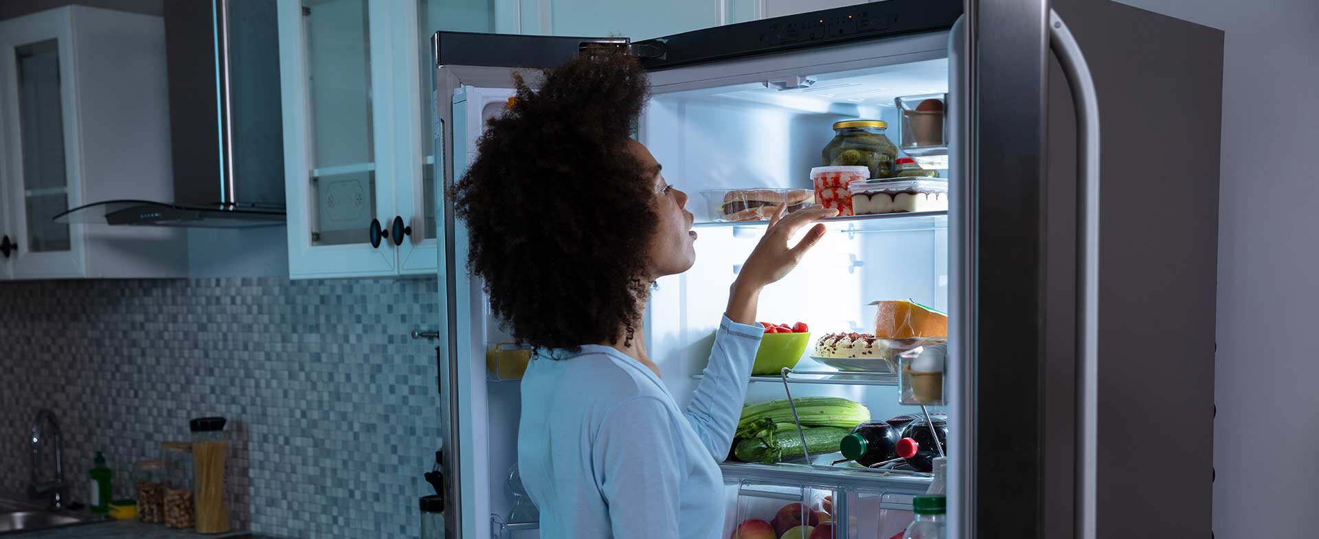 woman looking in the fridge