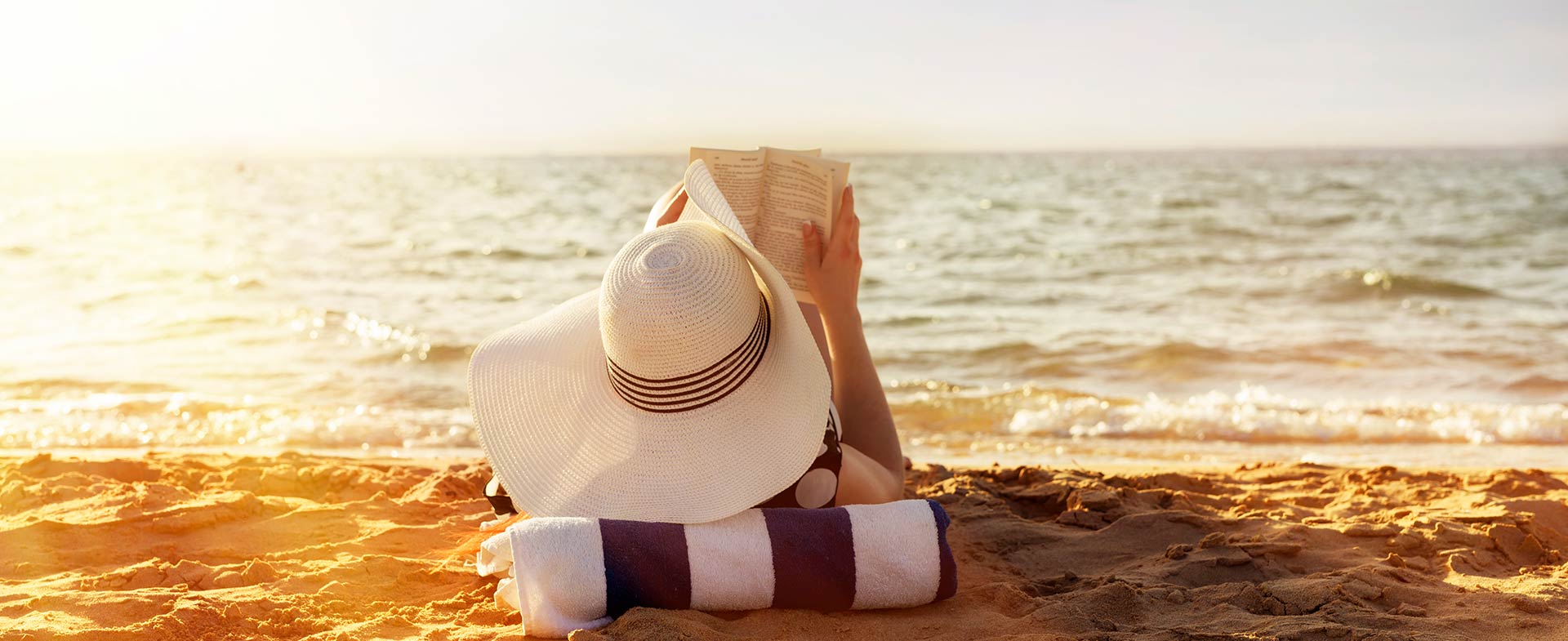 woman reading on beach