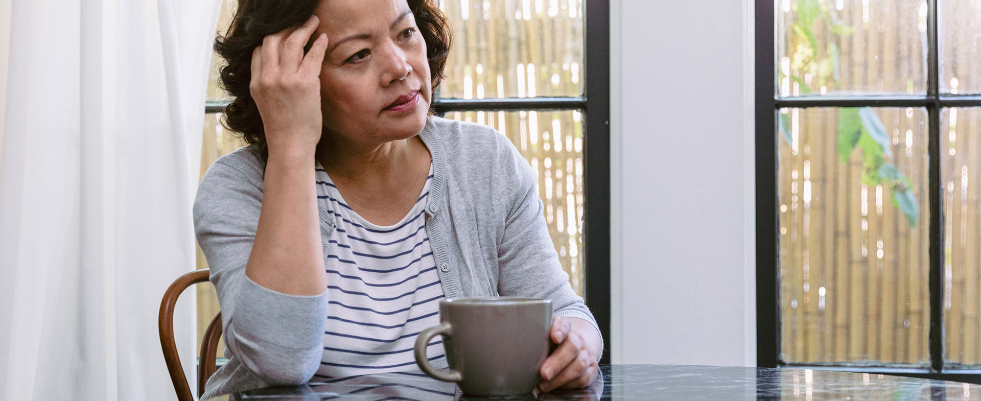 woman drinking coffee at table