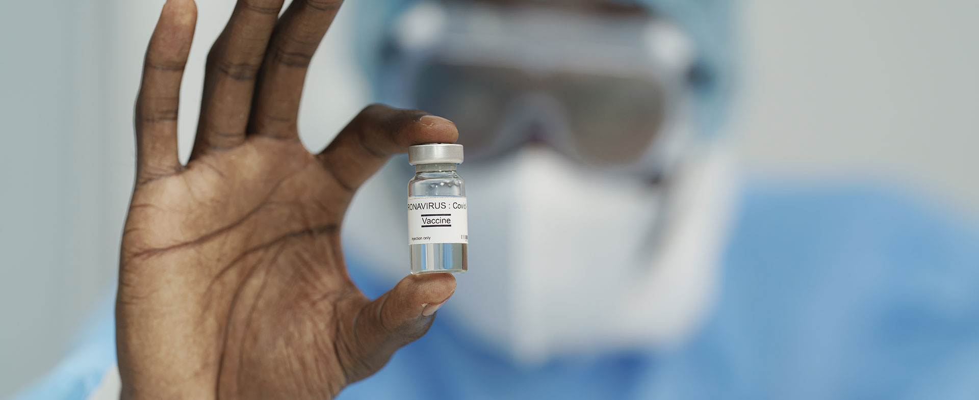 doctor holding covid vaccine