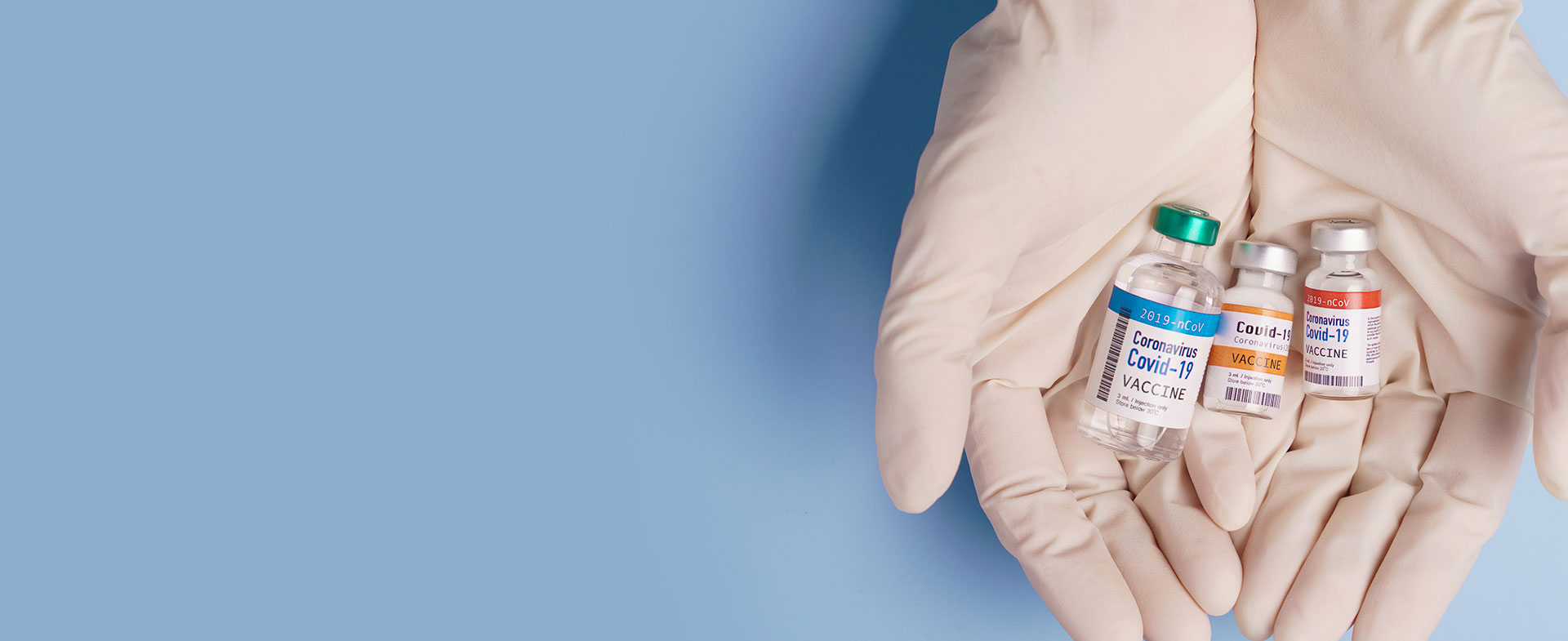 doctor holding vaccine bottles