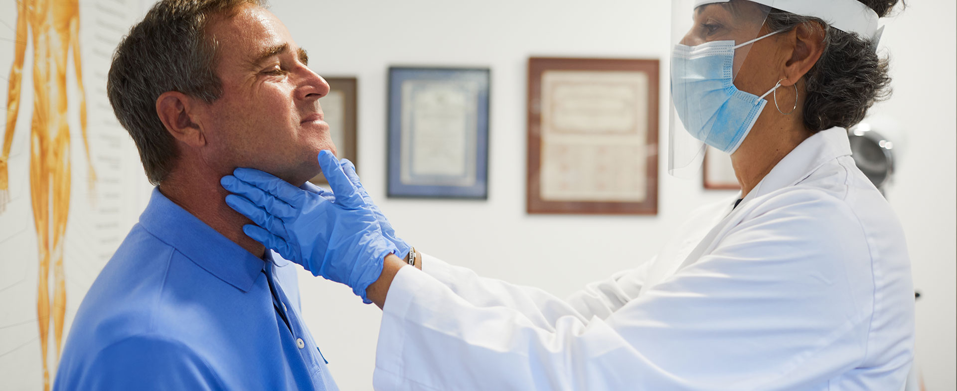 doctor checking patient thyroid