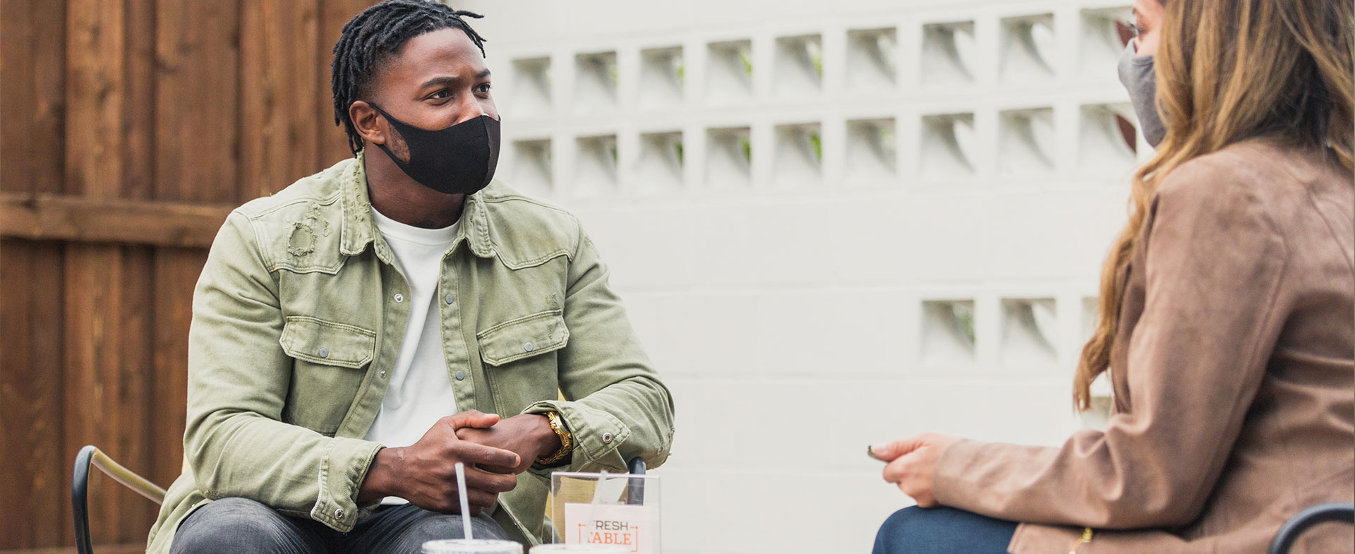two people talking in masks
