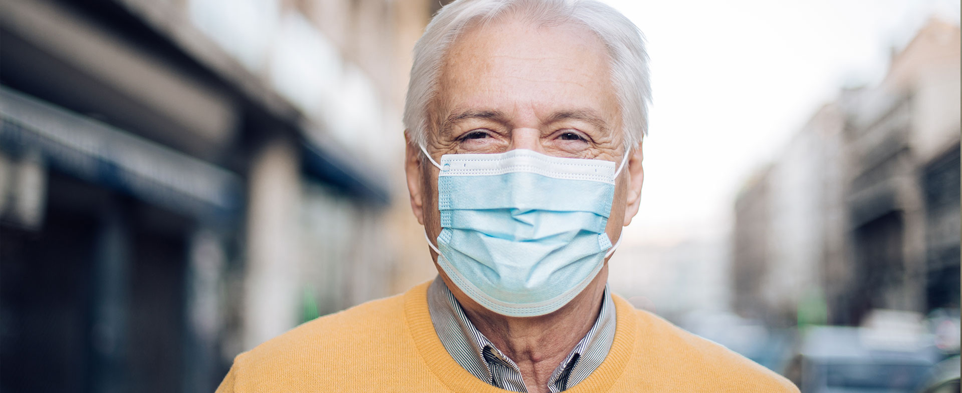 older man wearing a mask