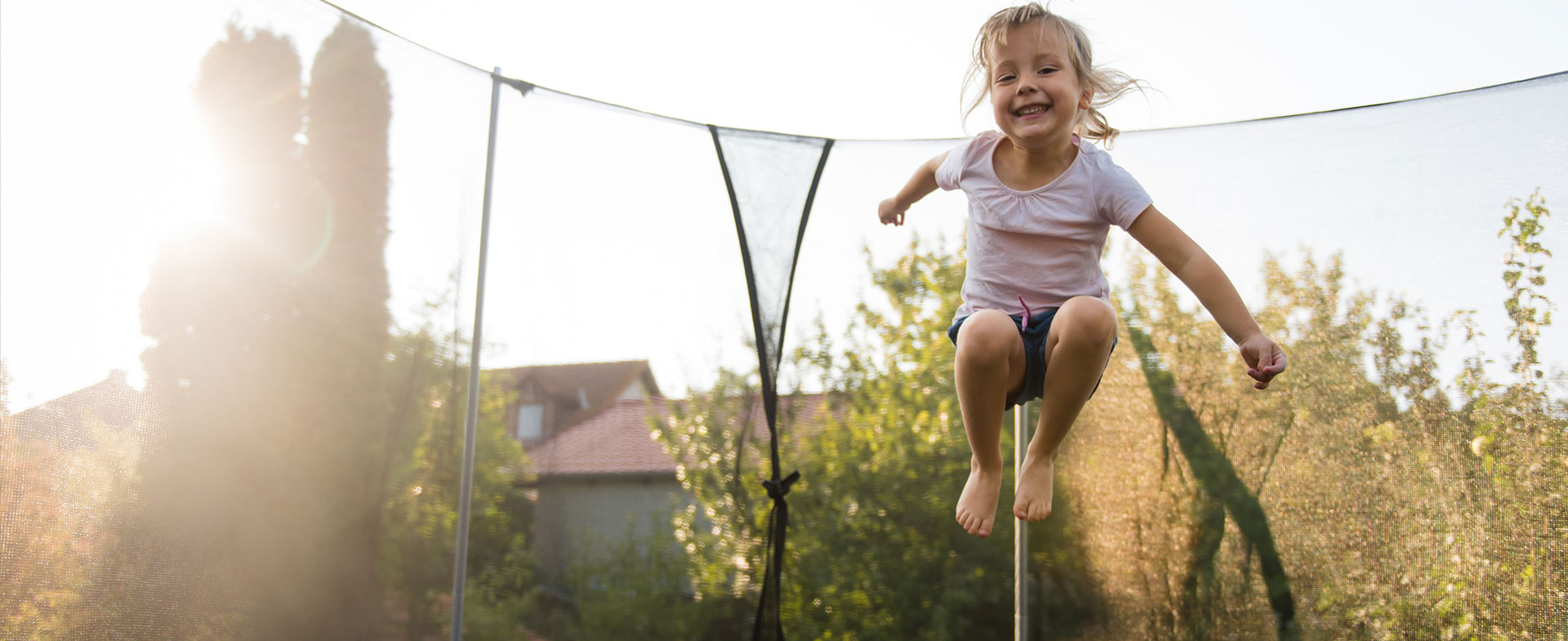 little girl jumping on trampoline