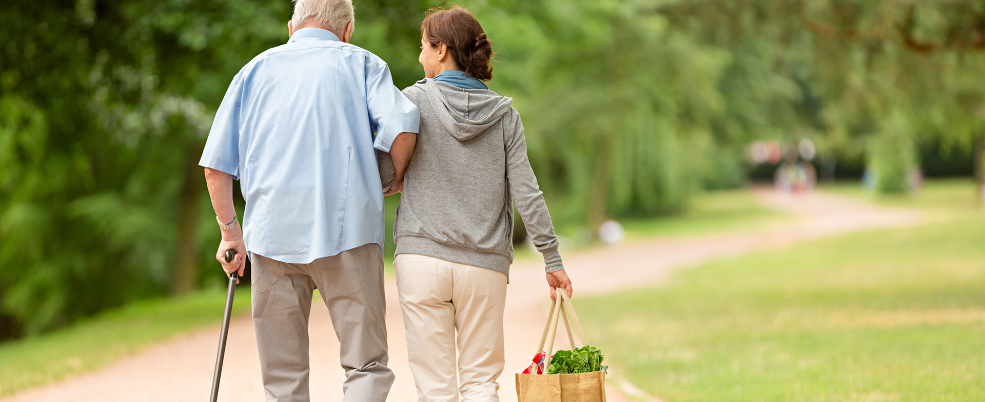 woman helping man with groceries