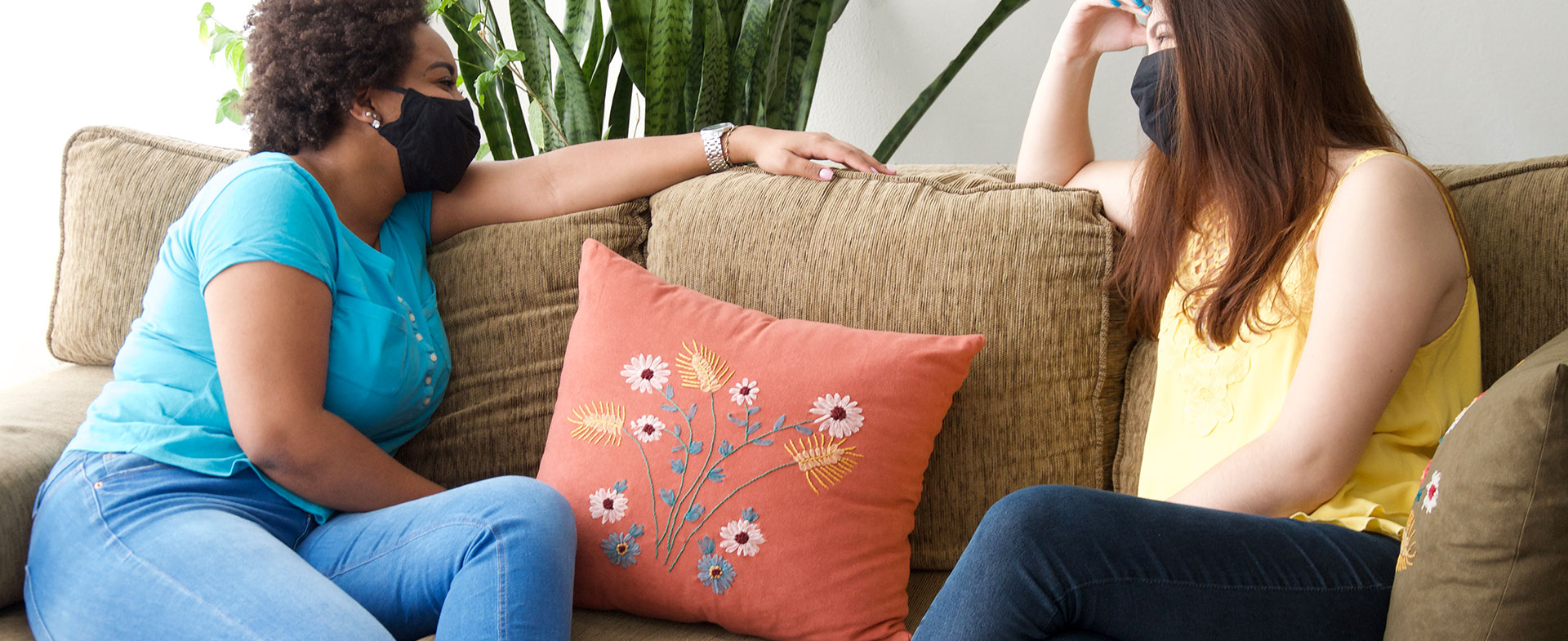 two friends talking in masks