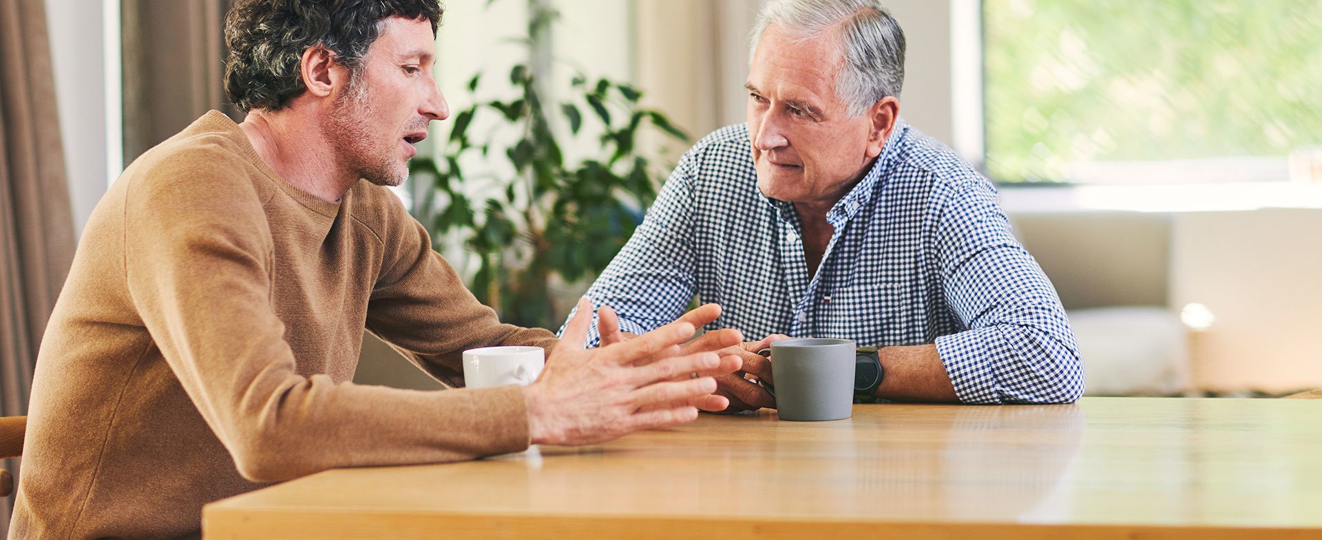 two men talking at table