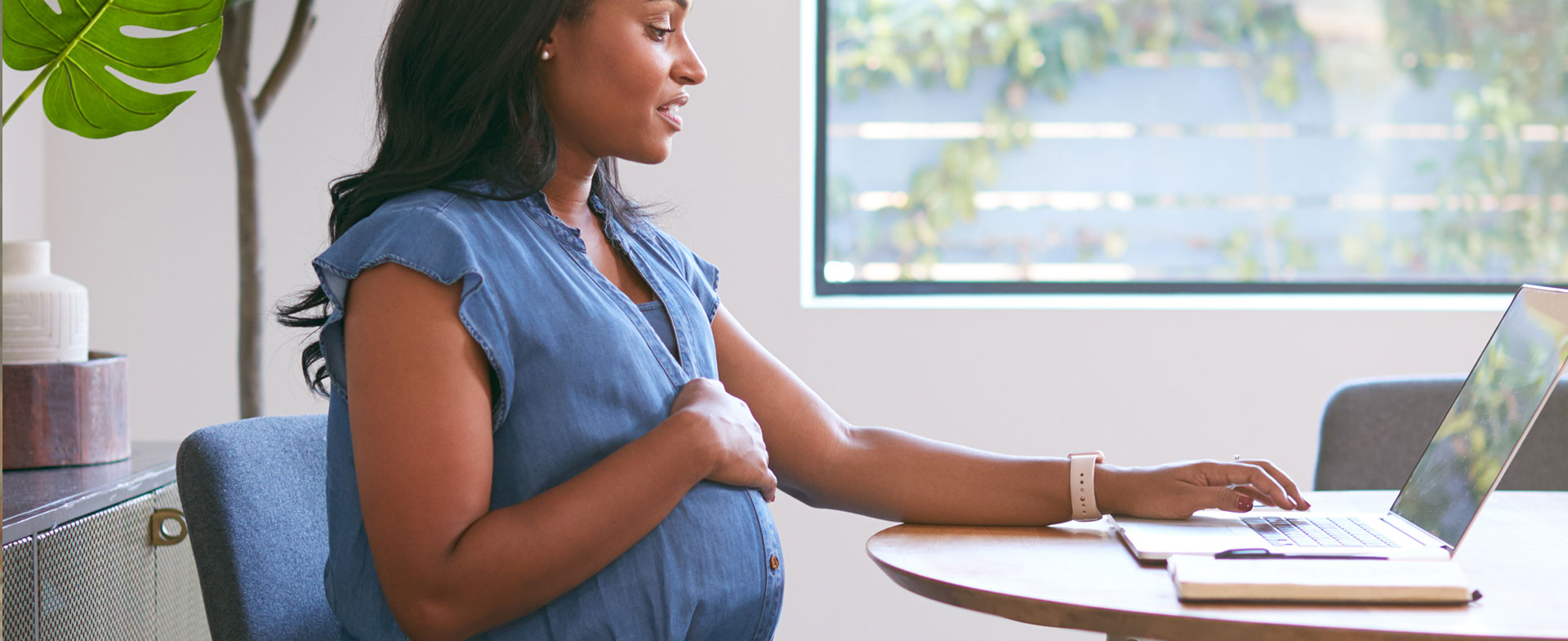 pregnant woman sitting at computer