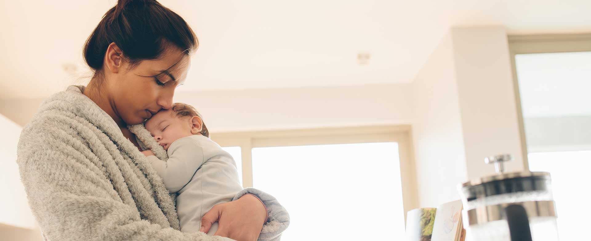 mom cuddling baby