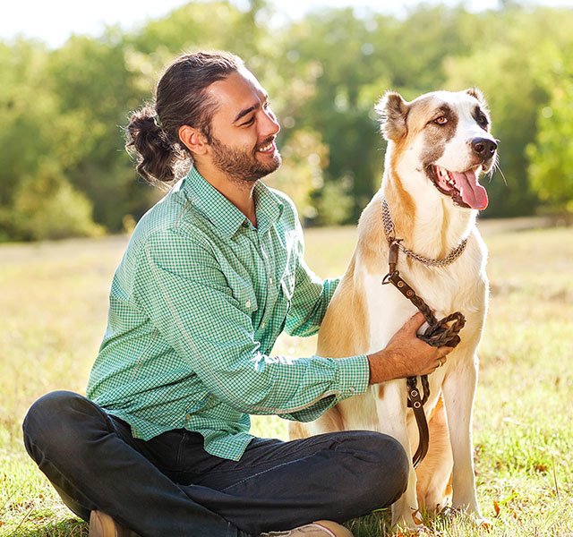man sitting with his dog