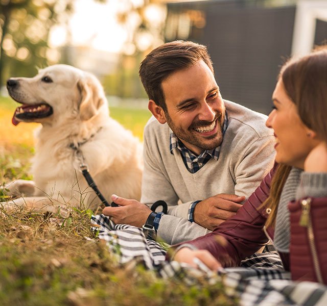 couple outdoors with their dog
