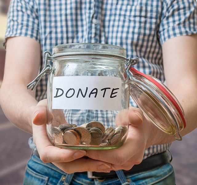 boy holding donation jar