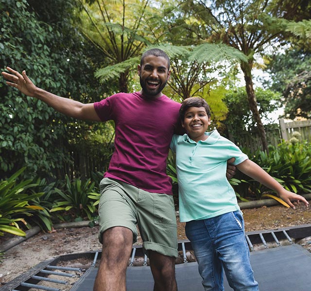 father and son on trampoline