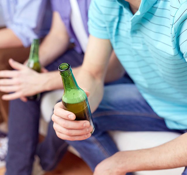 group of boys holding beers