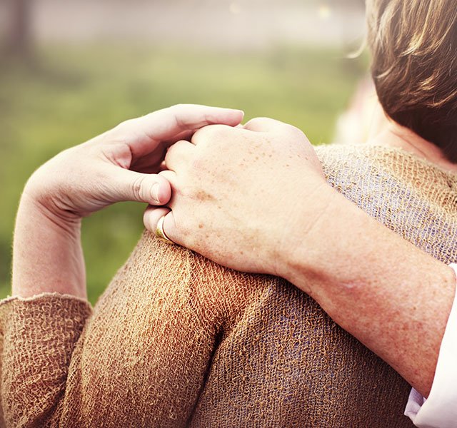 man with hand on womans shoulder