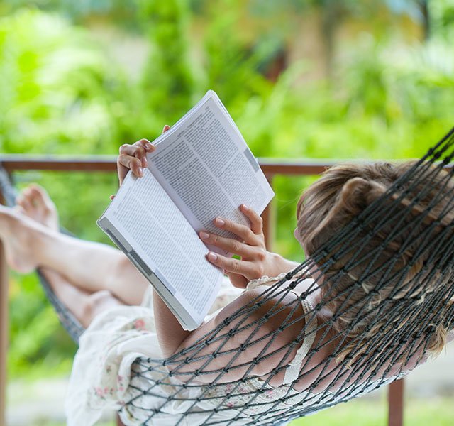 woman in hammock reading a book