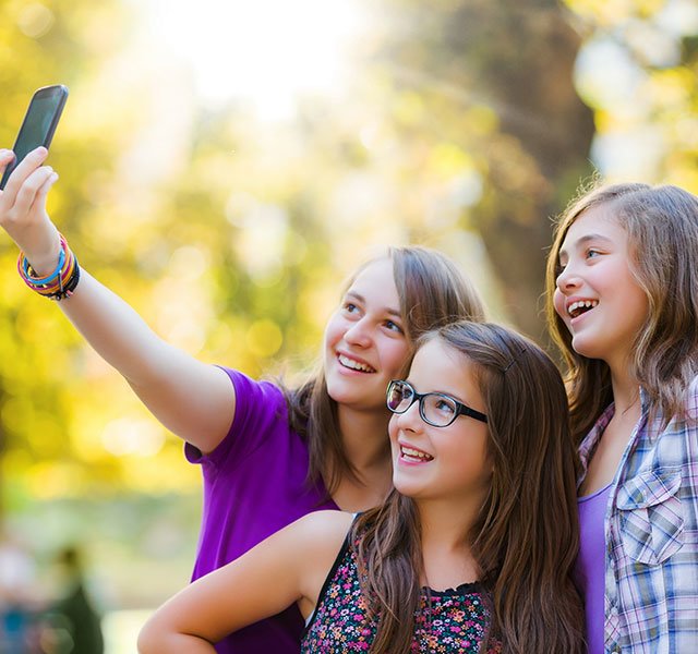 group of young girls taking a selfie