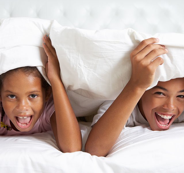 kids hiding under the covers