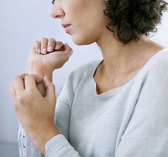 woman scratching her wrist