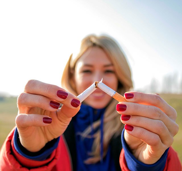 woman breaking cigarette
