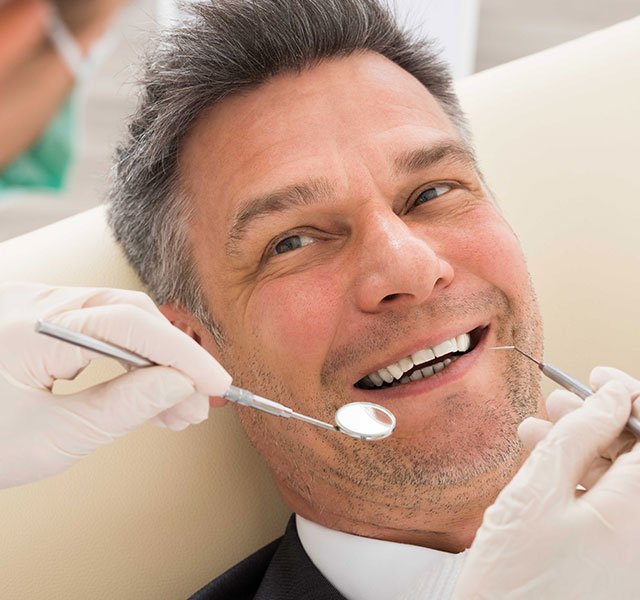 smiling man at dentist