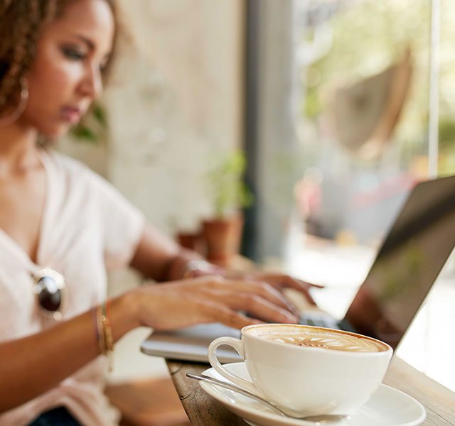 woman with coffee and computer