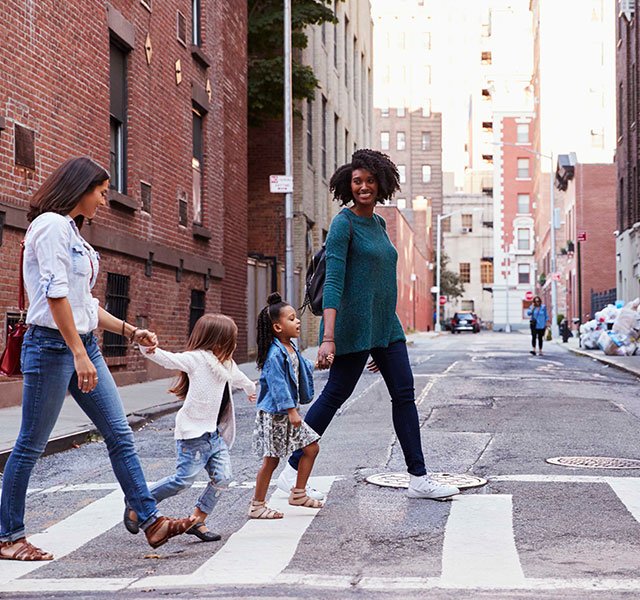parents and children crossing the street