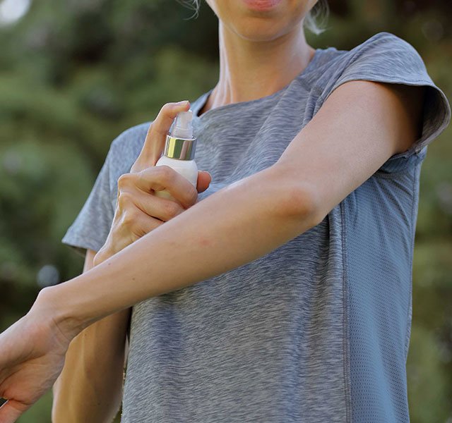 applying bug spray