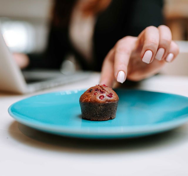 hand reaching for mini muffin