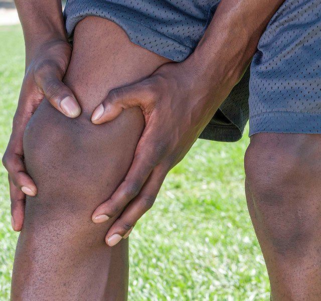 man holding his knee