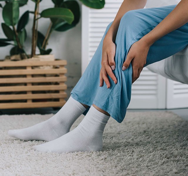 woman massaging leg