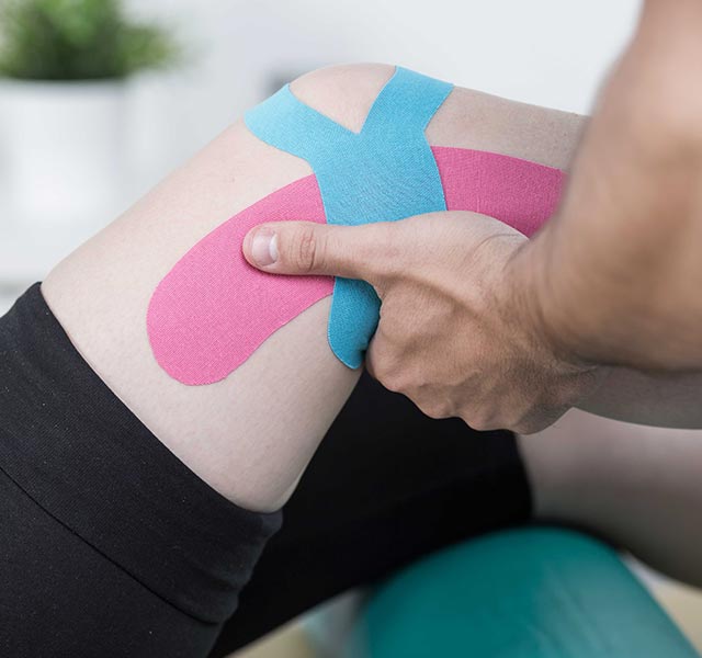 Kinesio tape application to the knee and thigh of the injured leg
