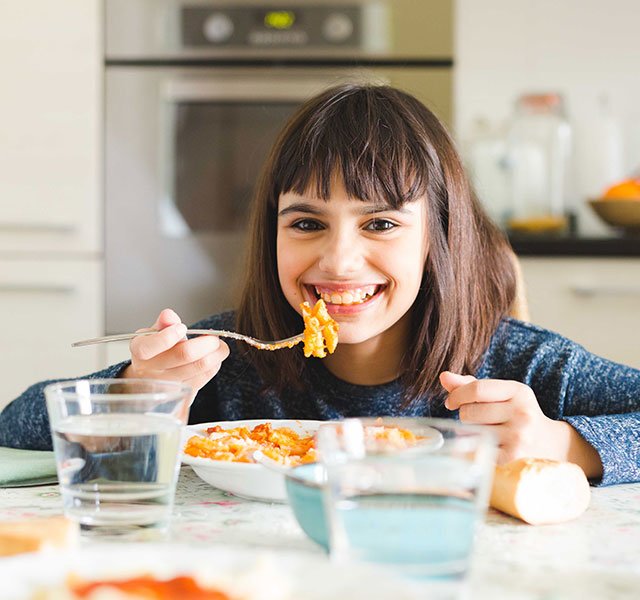 child sitting at counter eating