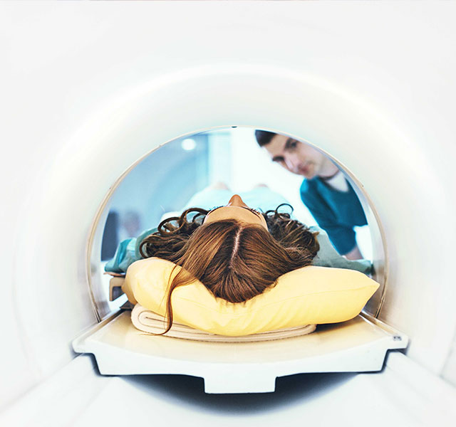 Woman lying on her back in an imaging machine