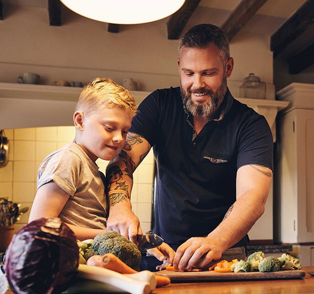 dad with son cooking